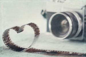 Heart shaped from film negative and old vintage camera - concept for photography